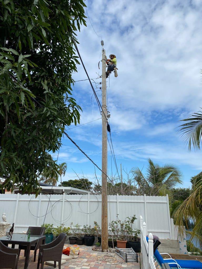 Jose Montes, working as an electrician on a utility pole 