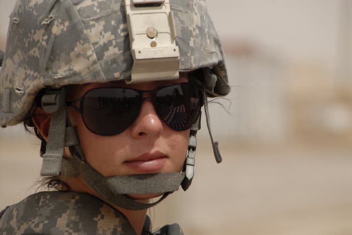 Close up of Megan Oster dressed in military attire and wearing sunglasses